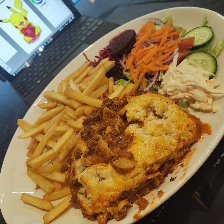 Lasagne served with chips, coleslaw and salad